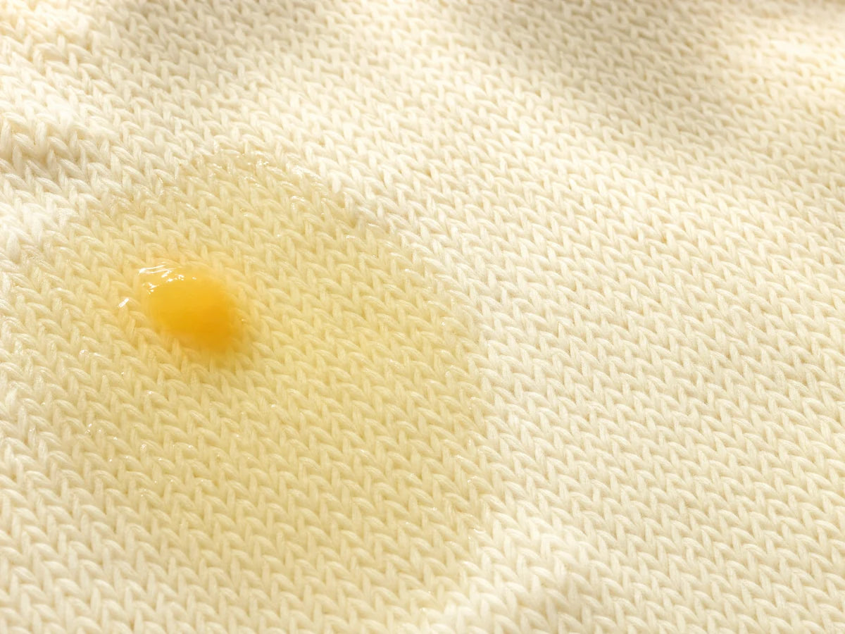 Eiwitrijke vlek op licht textiel